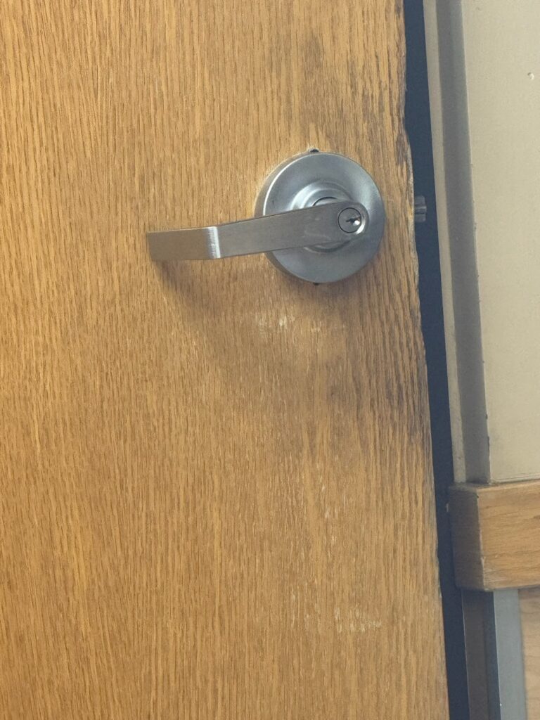 Residential locksmith unlocking house door handle in Lakewood CO